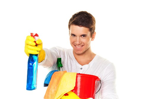 Kitchen cupboards and surfaces being cleaned in a Surrey move-in property